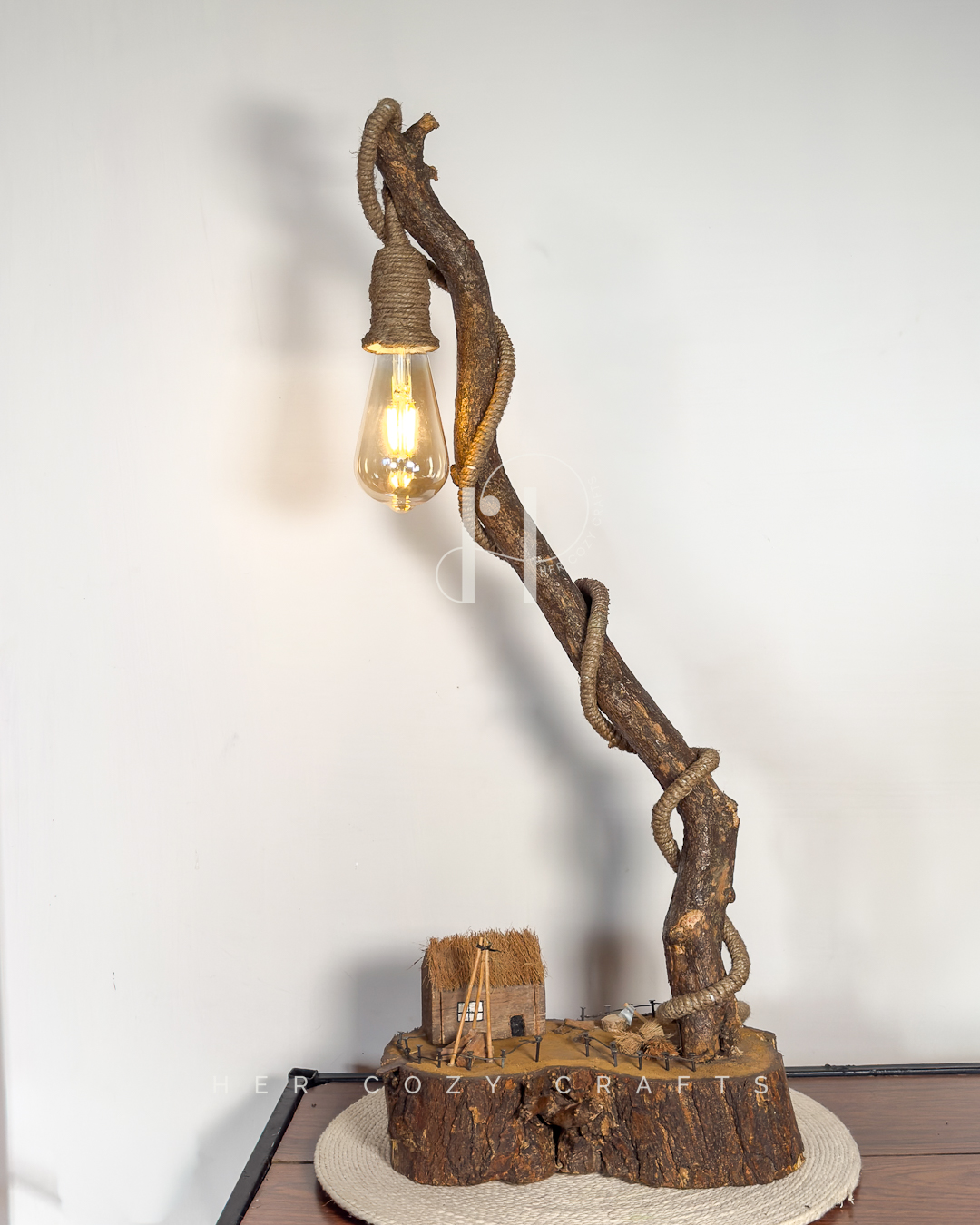 Meadow Rise Lamp - Slim branch frames cottage scene with gentle glow